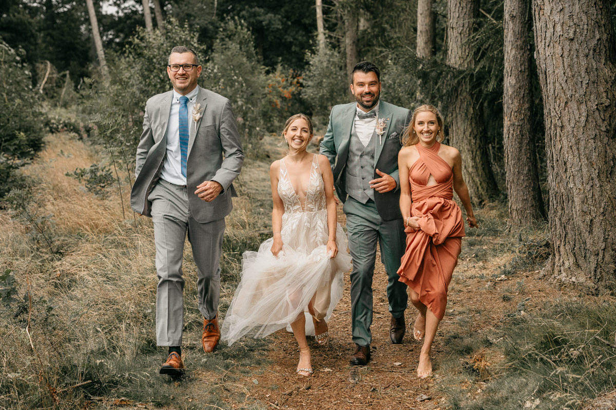 a group of people walking on a path in the woods