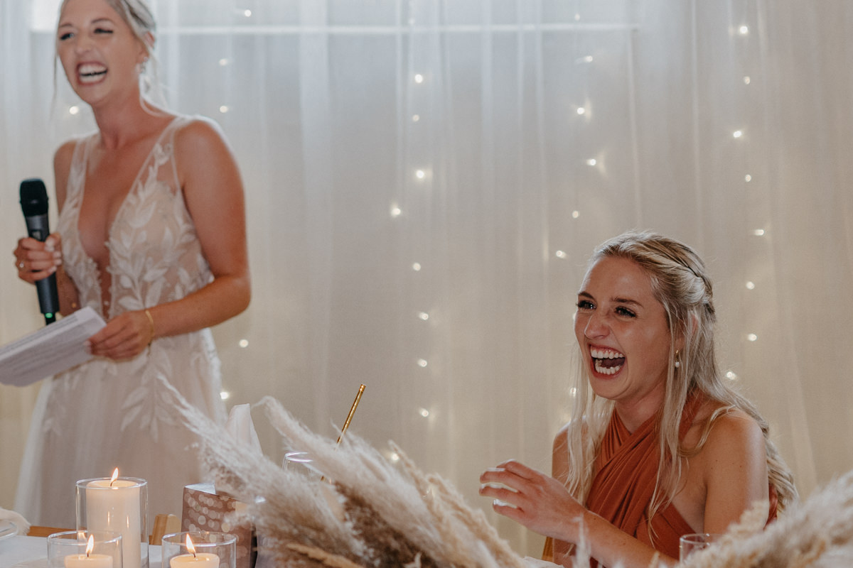 a group of women laughing at a table