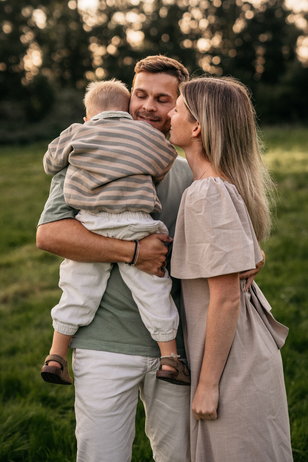 a man and woman holding a baby