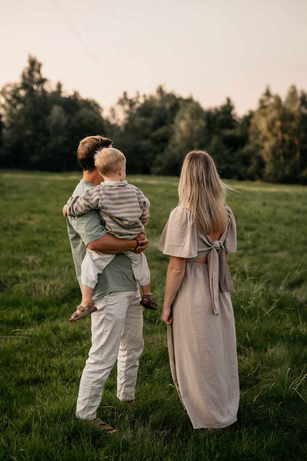 a man holding a child in a field