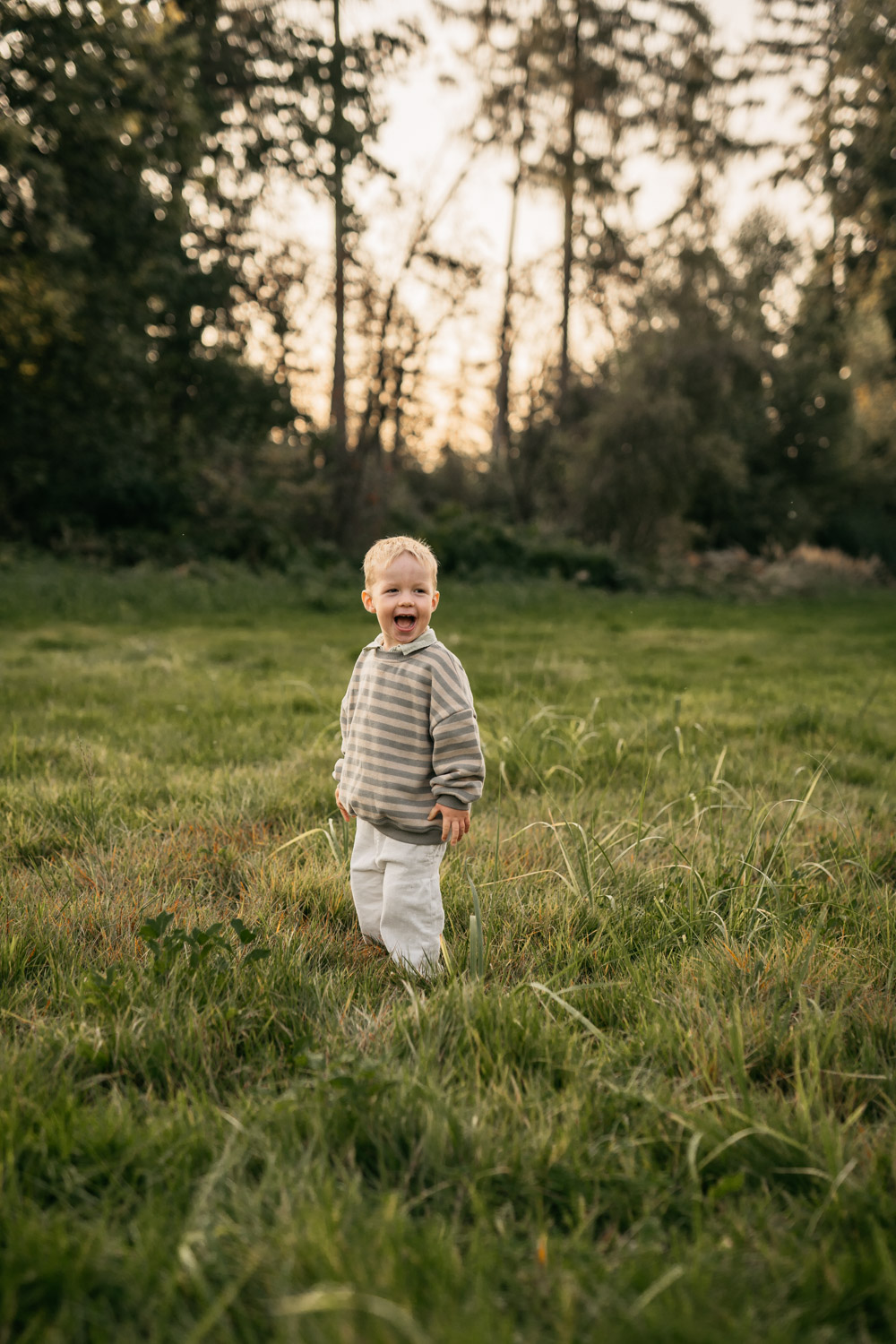 a child standing in a grassy field