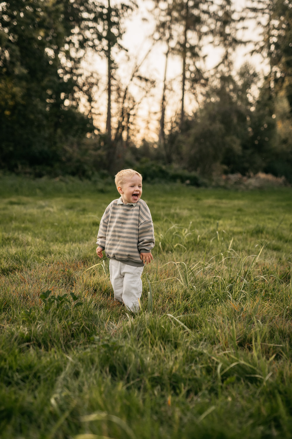 a child standing in a grassy field