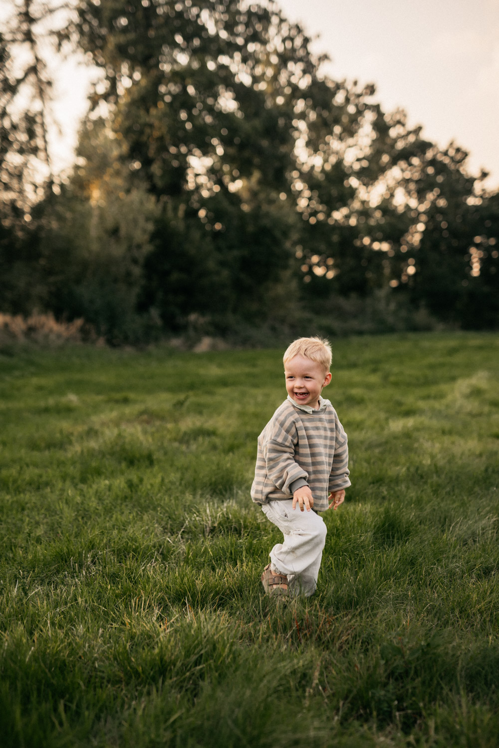 a child standing in a grassy field