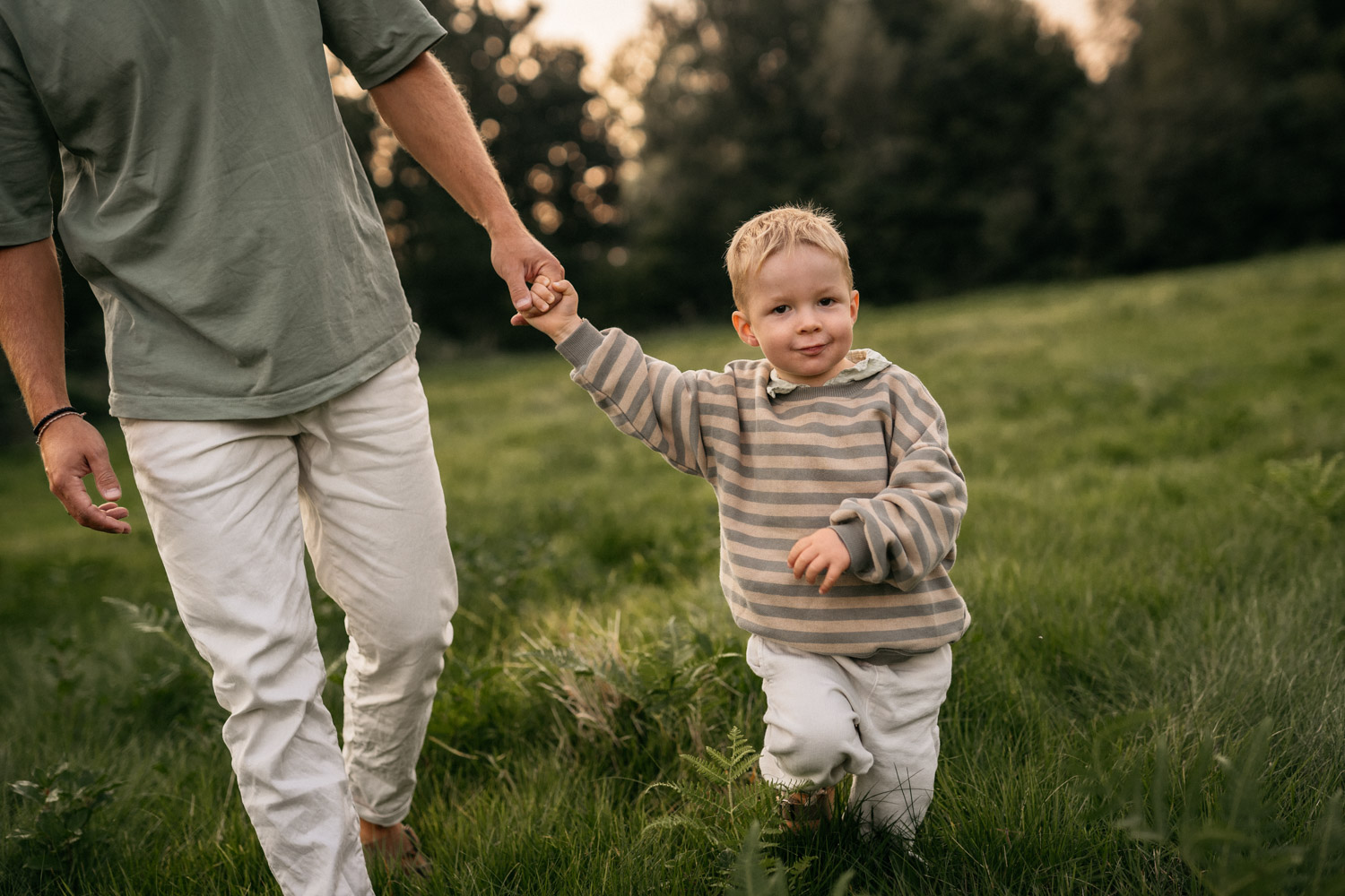 a man holding a child's hand