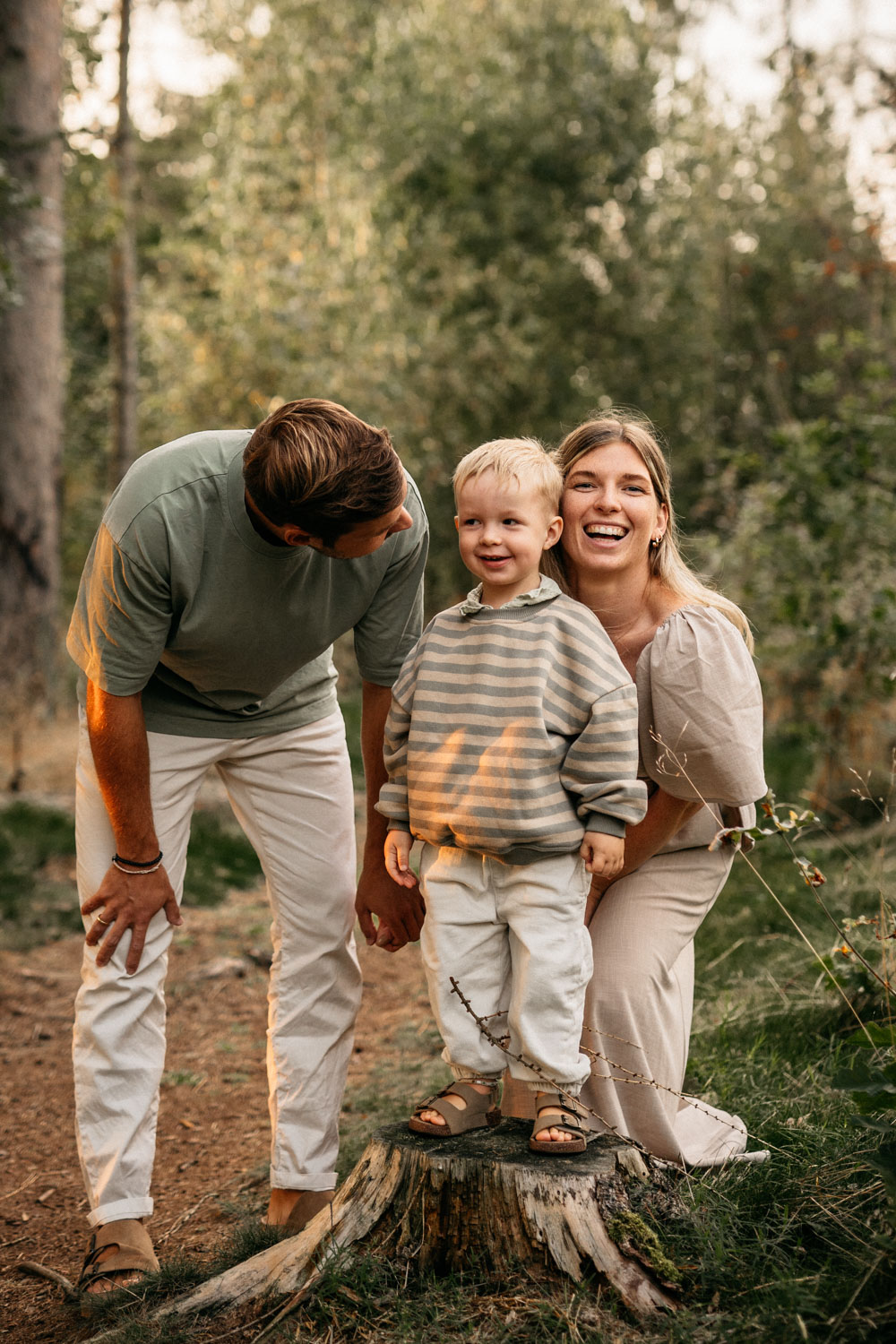 a man and woman standing next to a child