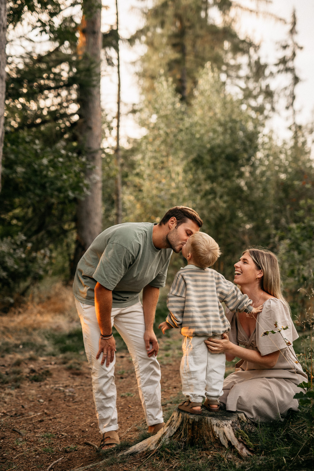 a man and woman kissing a child