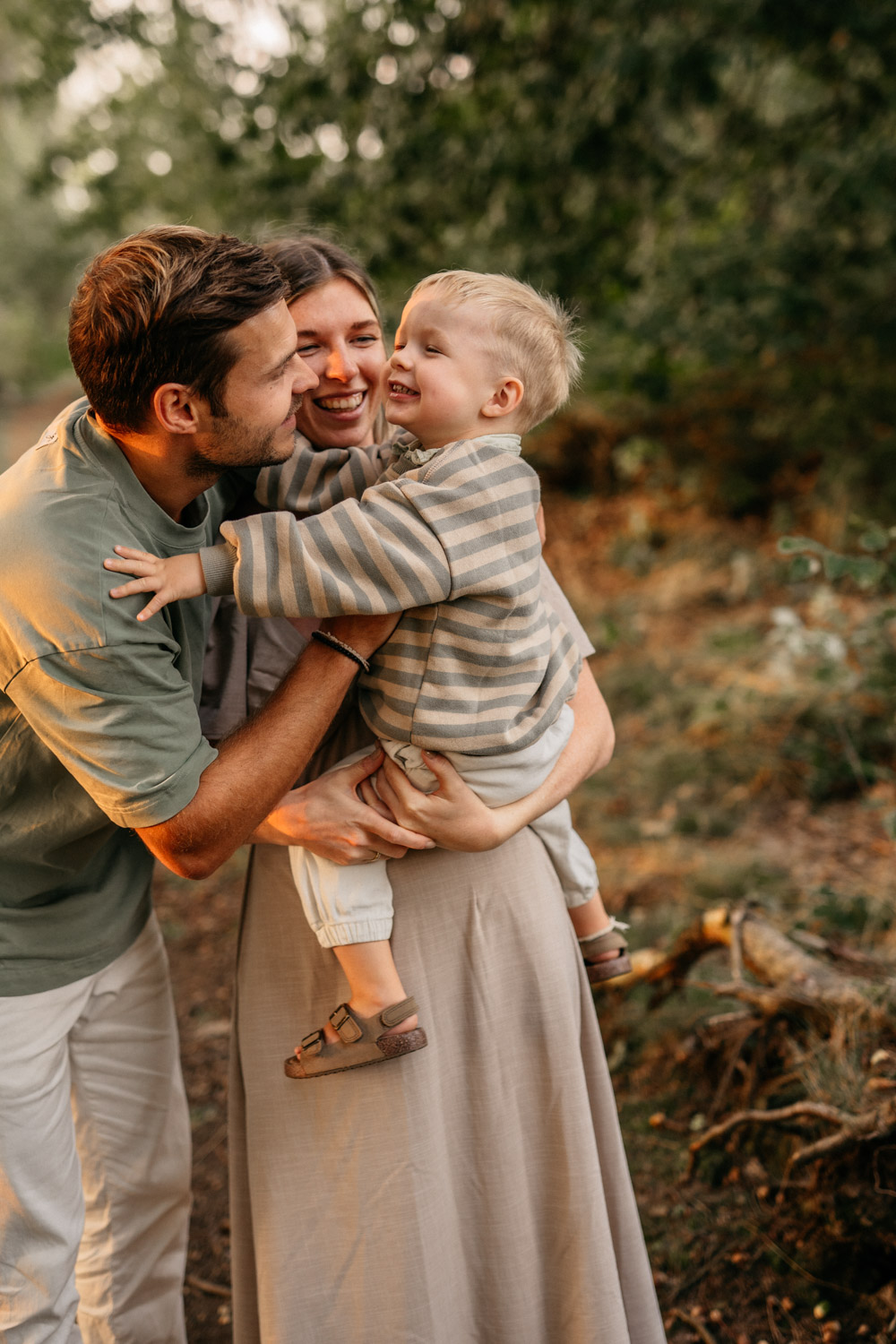 a man and woman holding a child