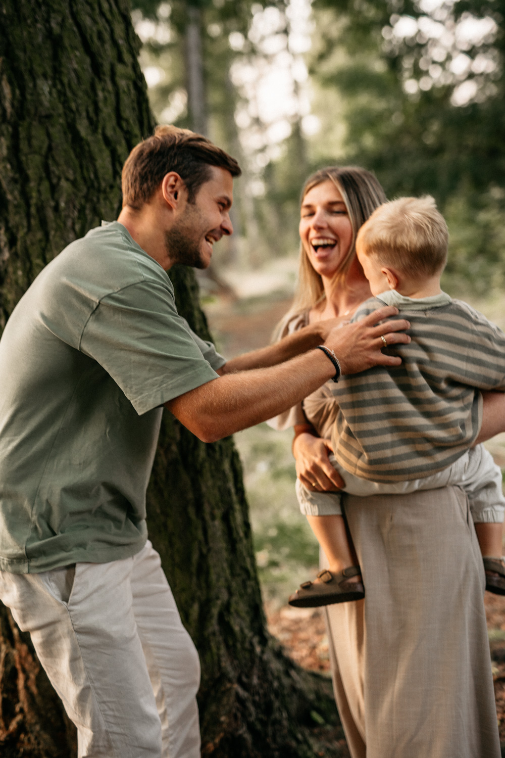 a man and woman holding a child