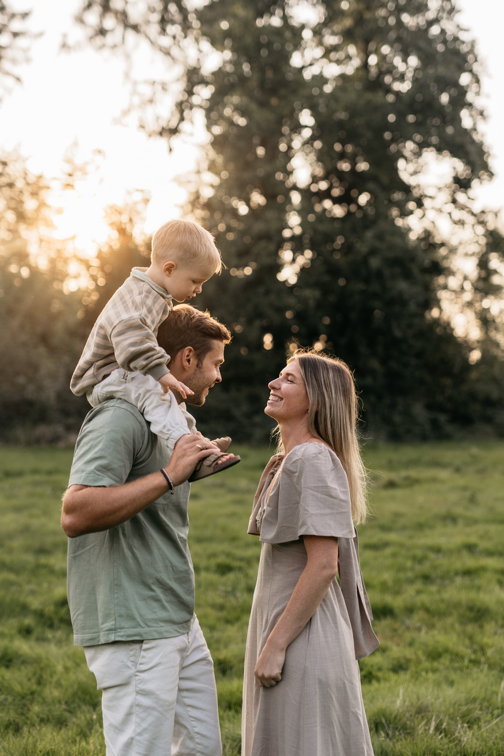 a man and woman with a child on their shoulders